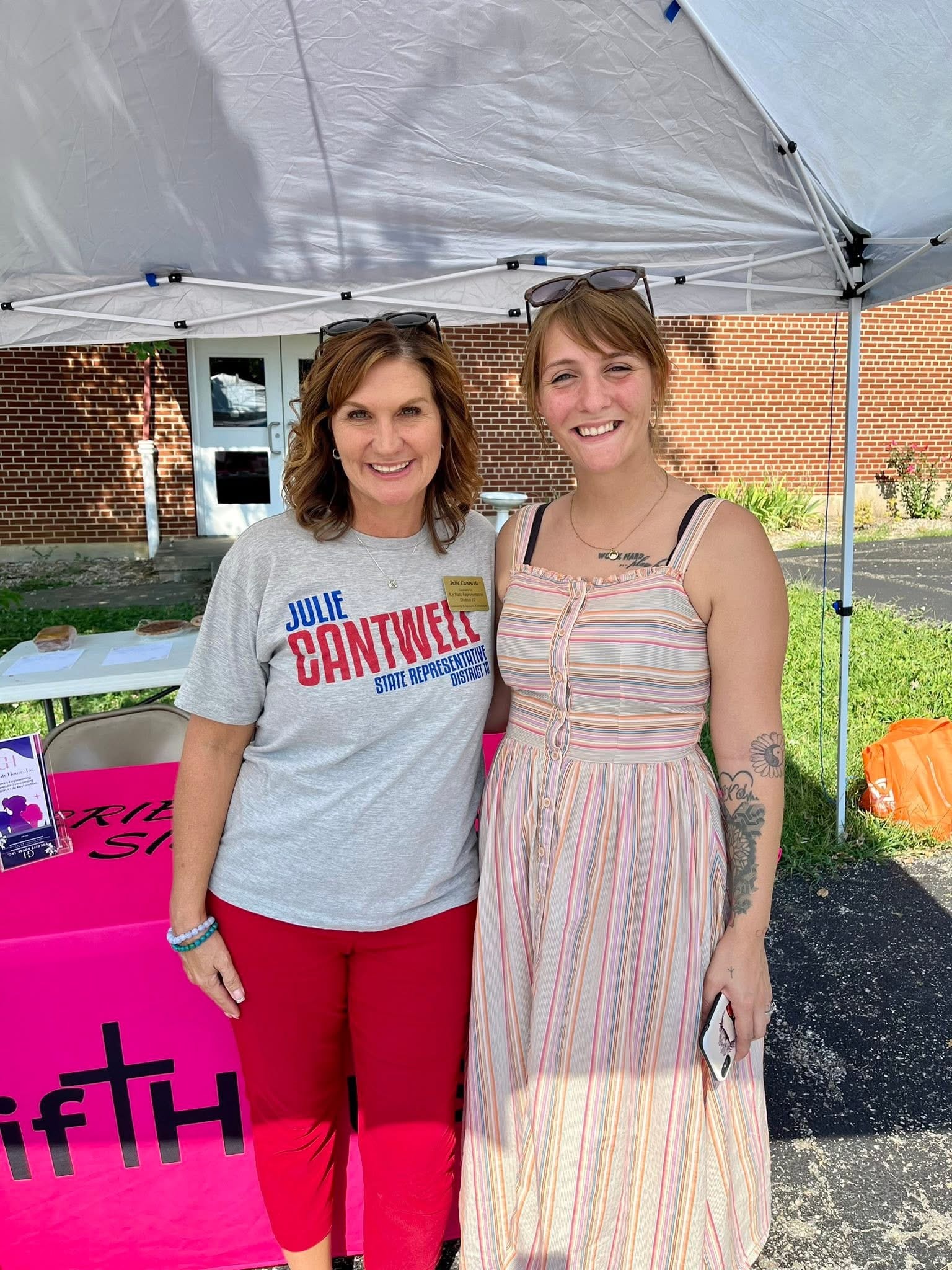 Two Gift House women at a community outreach event