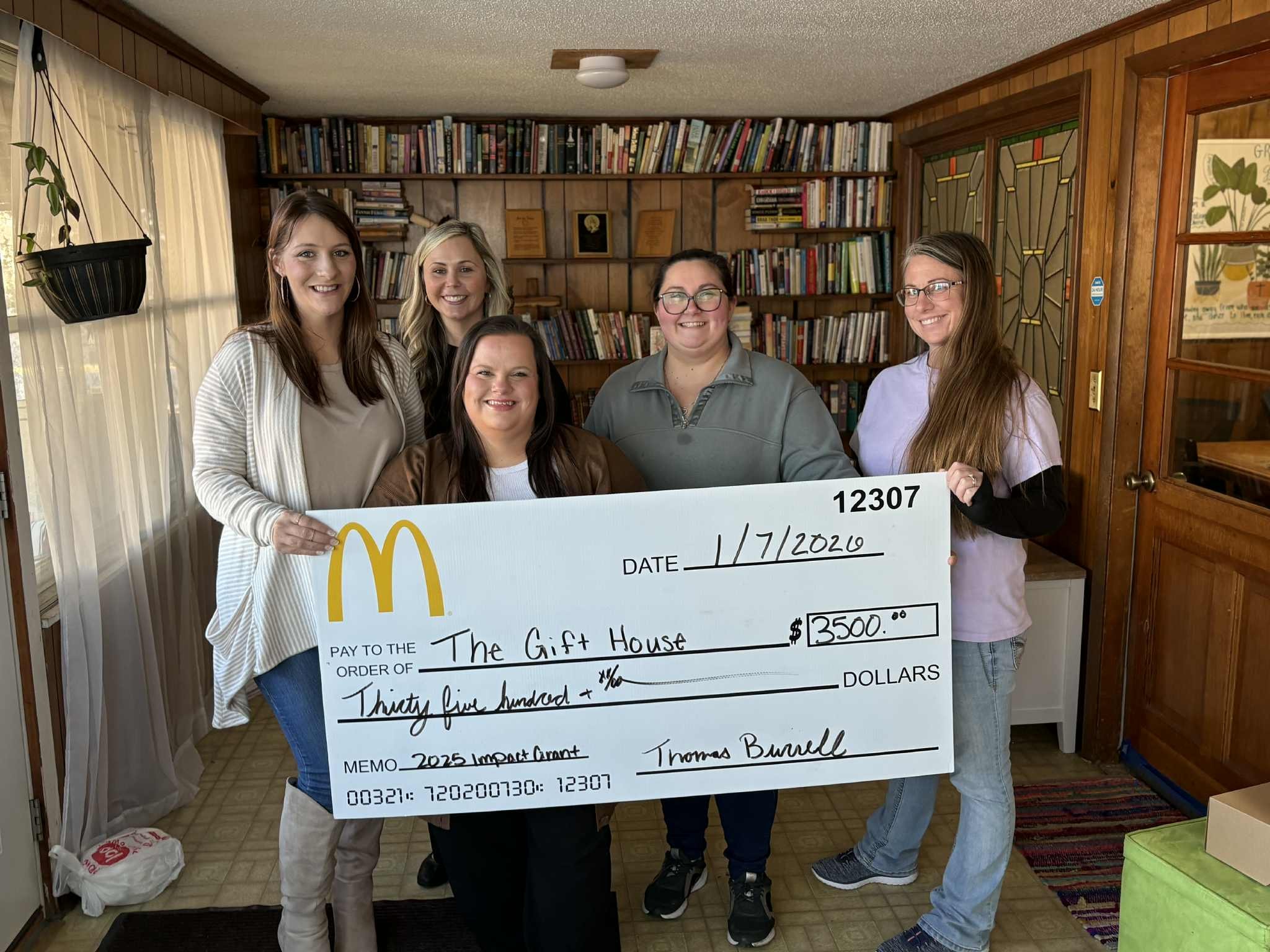 The Gift House team receiving a $3,500 McDonald's Impact Grant donation check